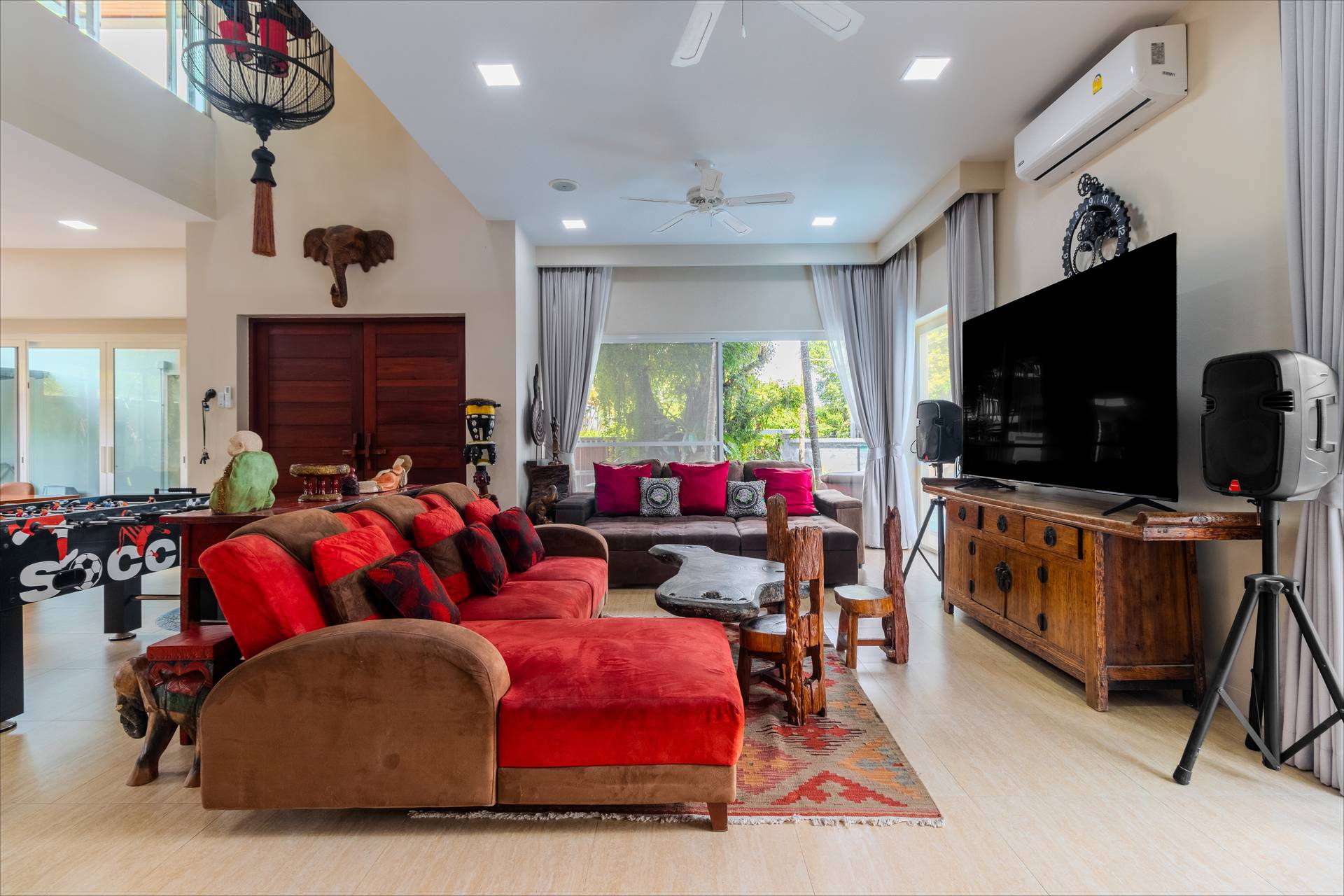 Open-plan living area with plush sofas and traditional Asian furnishings