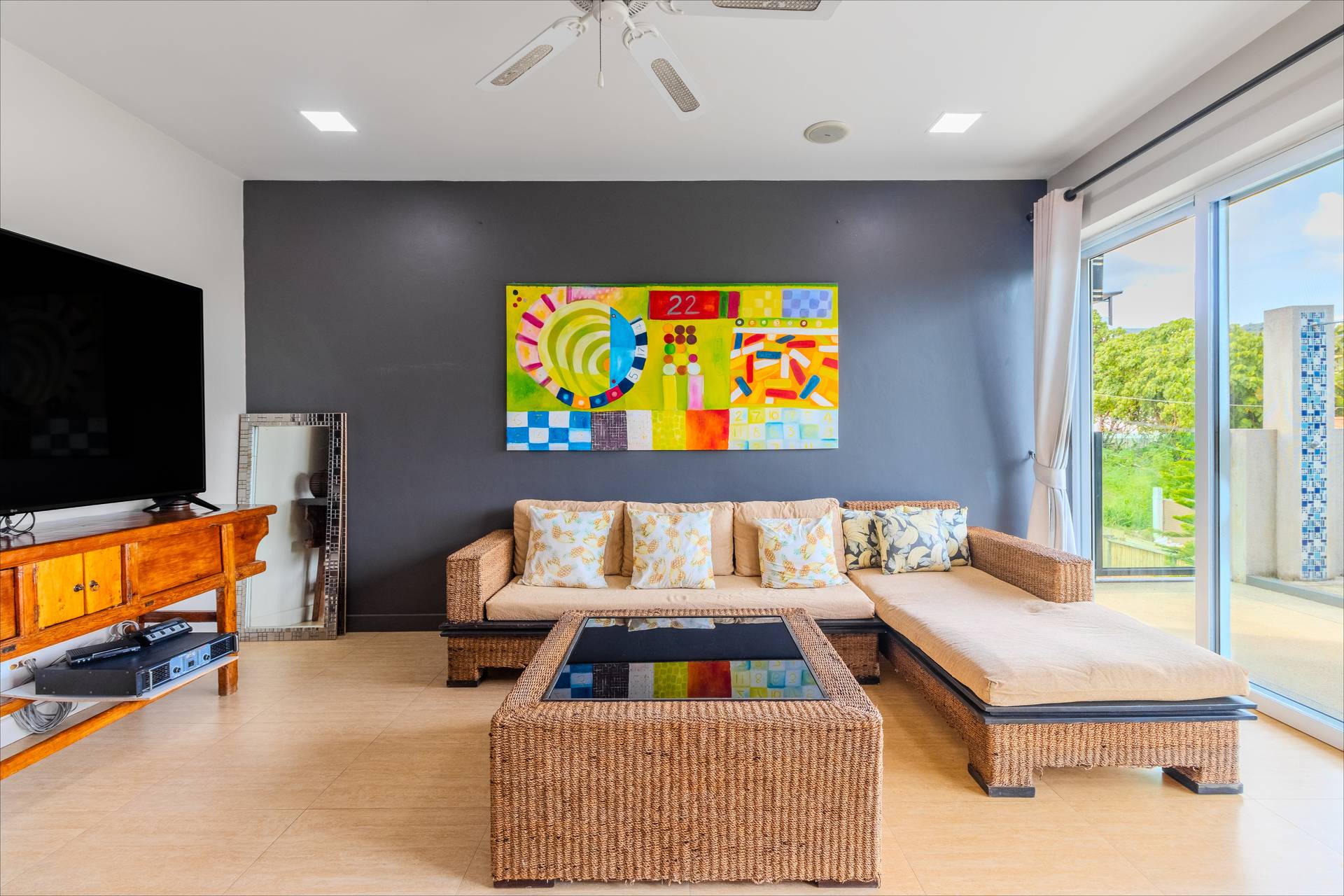 Expansive open-plan living area with soaring ceilings, designer furniture, and seamless garden access
