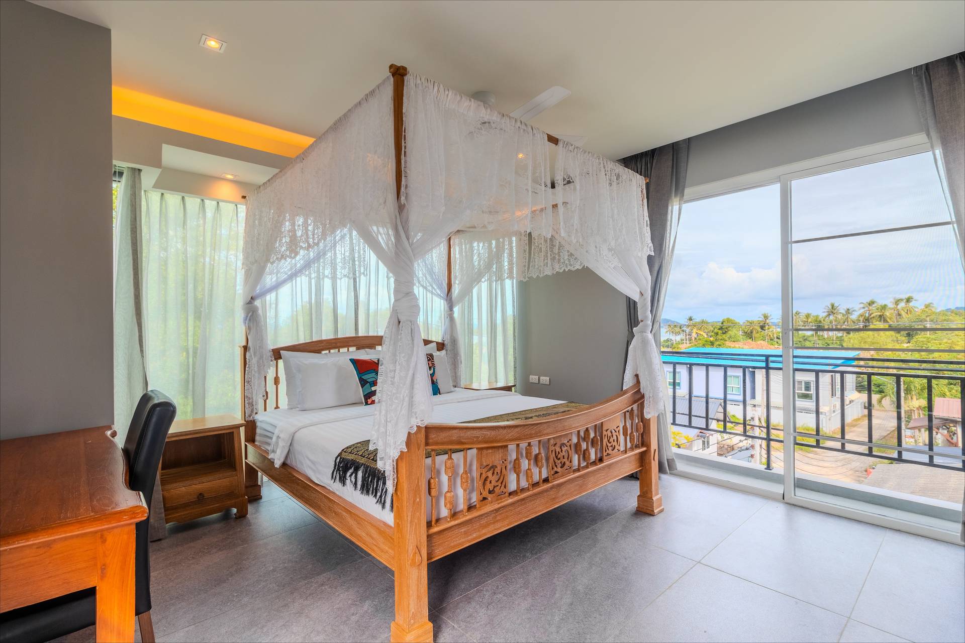 Airy four-poster canopy bedroom with panoramic views and desk area