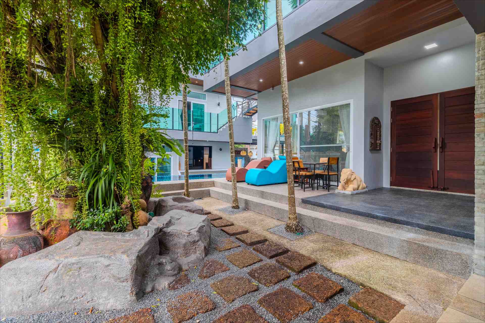 Villa courtyard entrance with stone pathway and elephant sculptures
