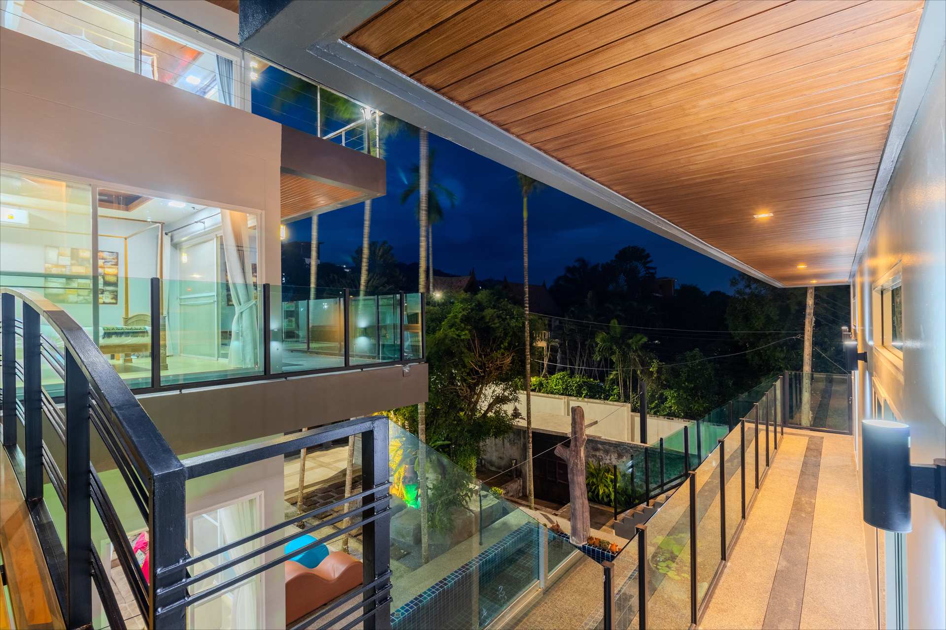 Outdoor ping pong table and kitchen bar with pool views at twilight